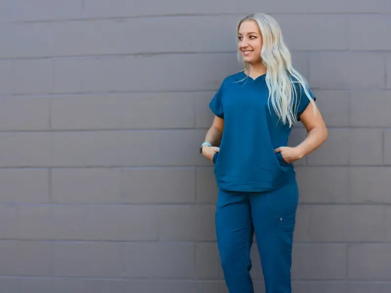 Woman in Atmos scrubs at Scrubs by Identity Factor in Bartlett.